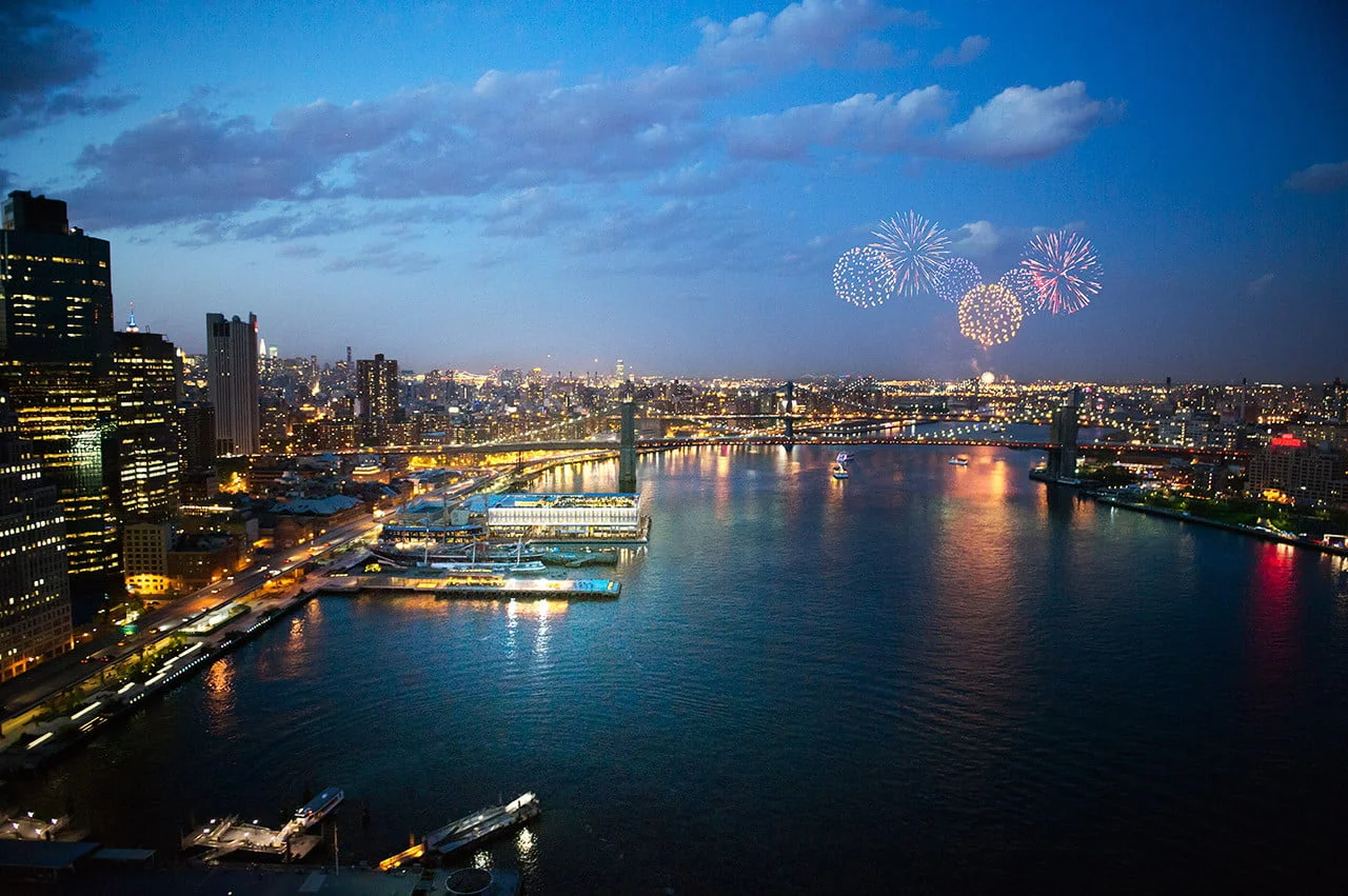 Looking North on East River of Brooklyn Bridge during fireworks celebration